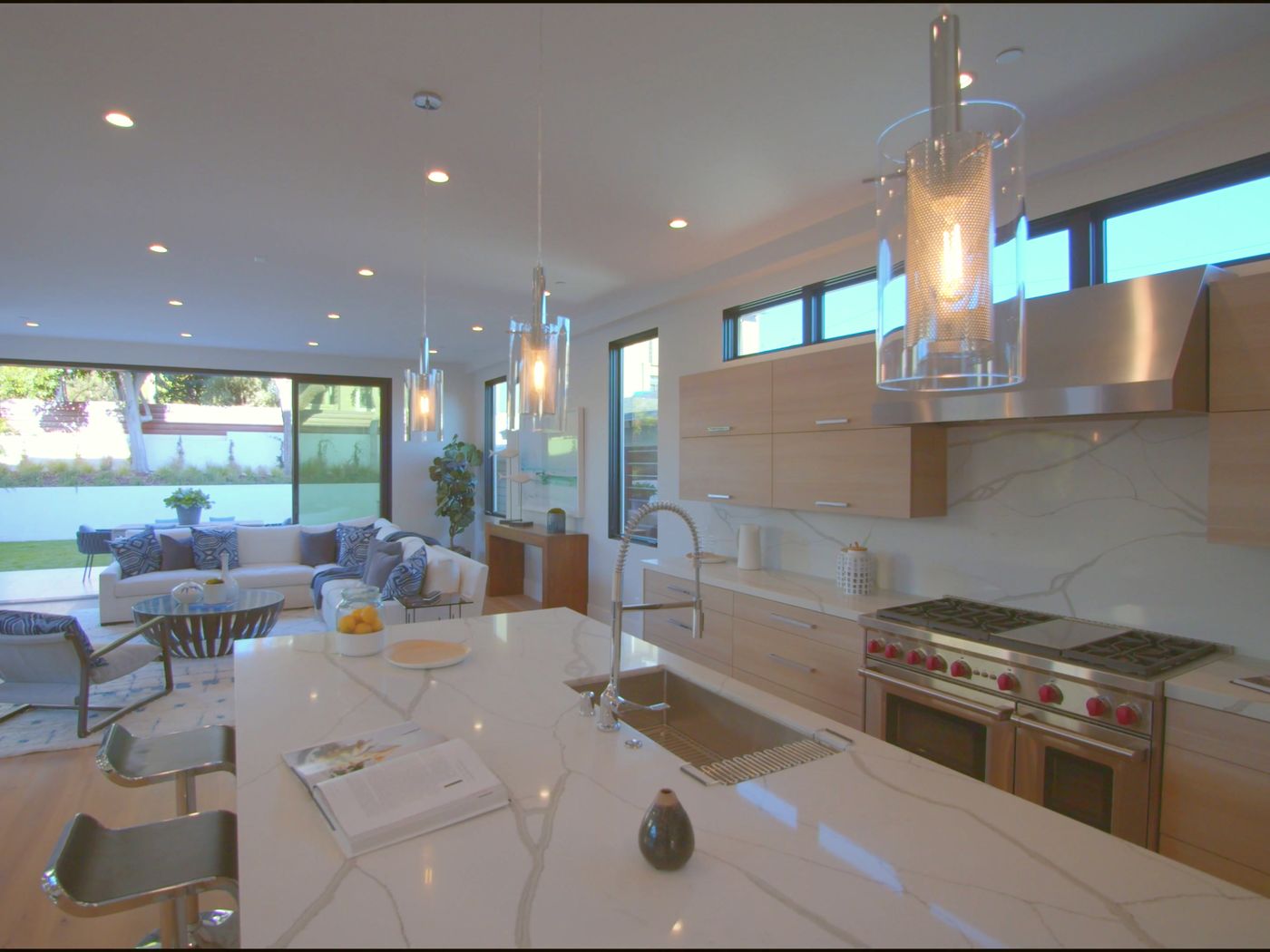 Kitchen with a marble island and professional range